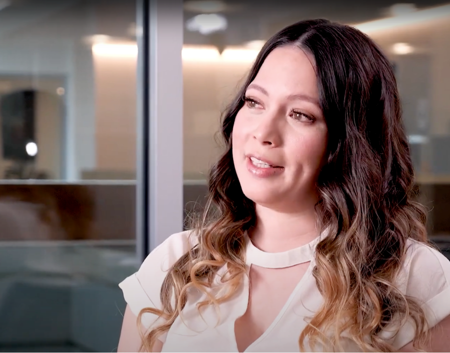 Woman thinking about her time at AAA, sitting in a conference room