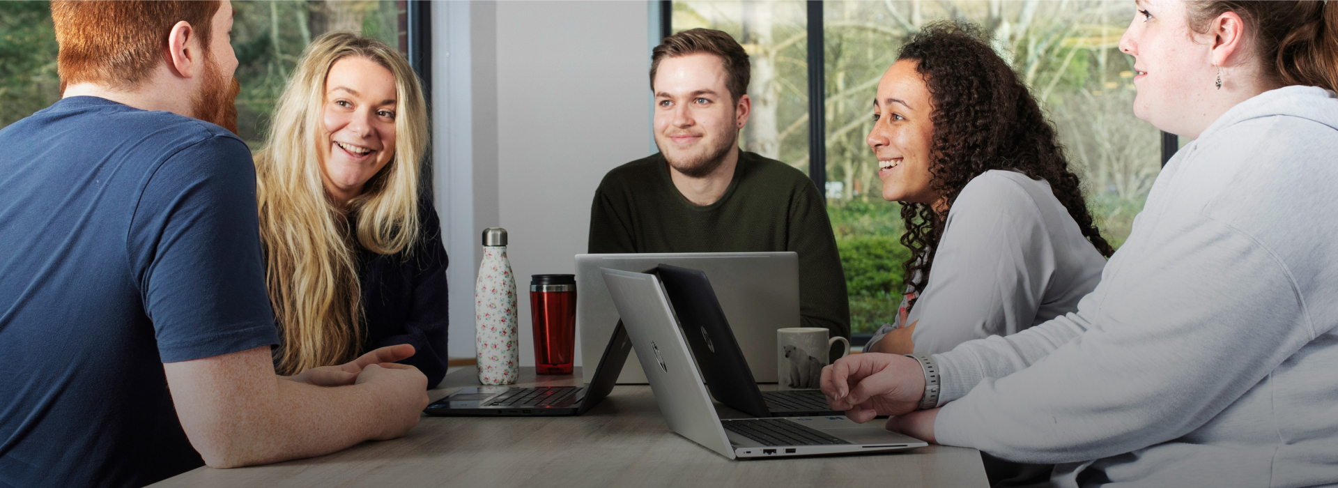 Woman at laptop smiling 