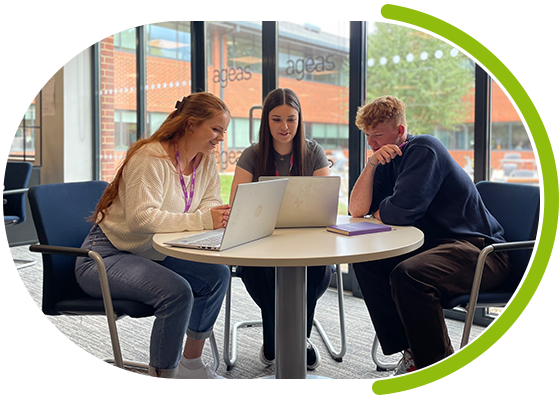 Image of three young people sitting around a table