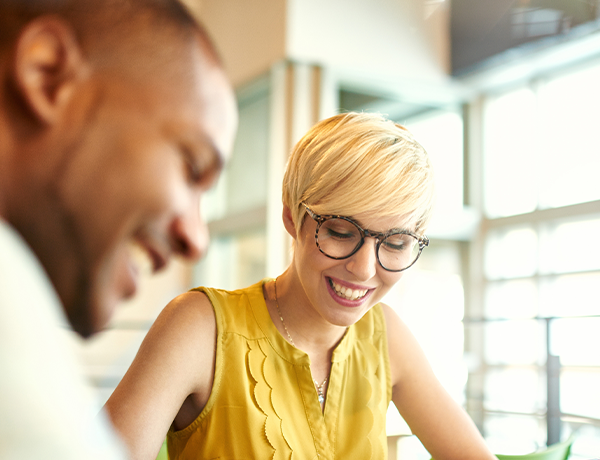 Employees are smiling in a casual social setting.