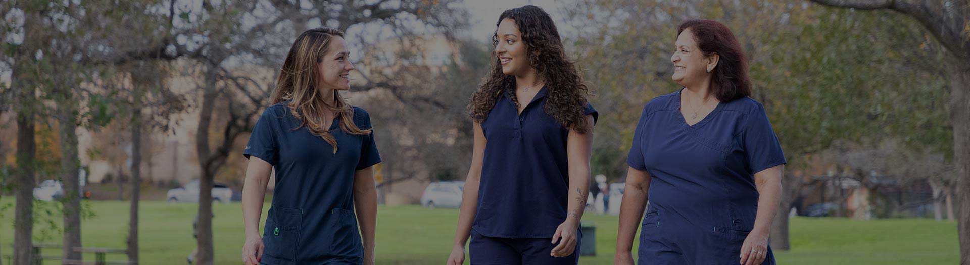 Page Header Image - Ascension Benefits & Perks - Three female nurses walking in park setting