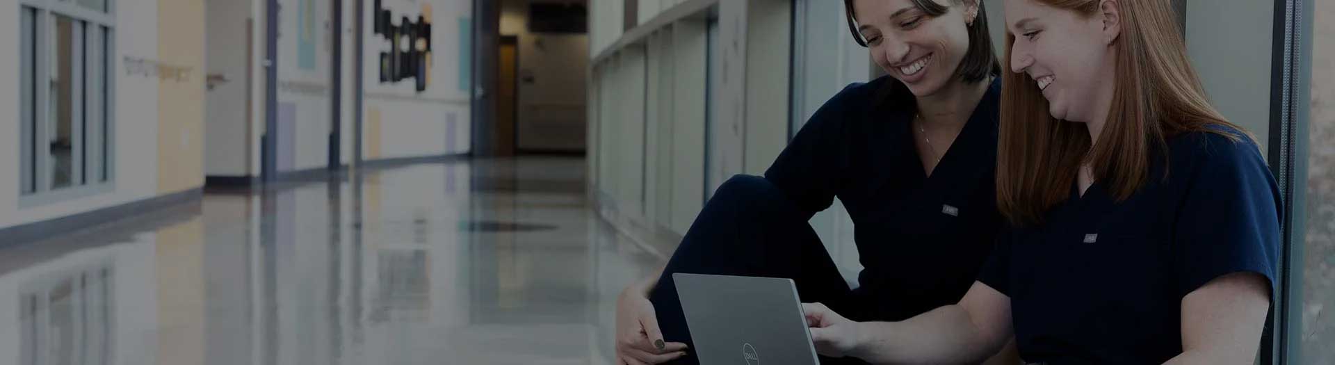 Page Header Image - Grow with Ascension - Two medical professionals having a discussion in hospital hallway