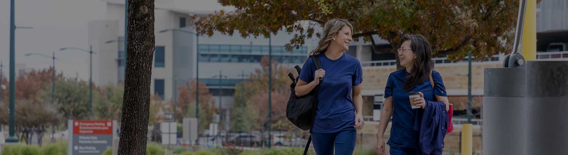 Page Header Image - Ascension Travel Jobs - Two female medical professionals walking with packed suitcases