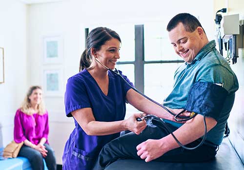 Tile - Ascension Medical Group - Medical professional checking patients blood pressure
