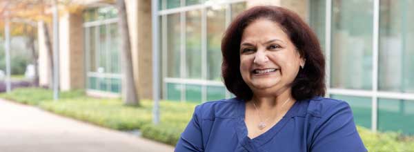 Tile - Ascension Nursing Support - A mature female nursing assistant outside, smiling into camera