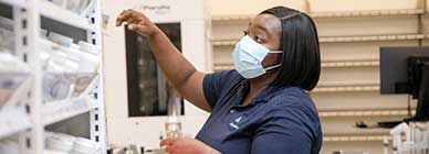 Tile - Ascension Allied Health Pharmacy - Female pharmacy tech at prescription shelves