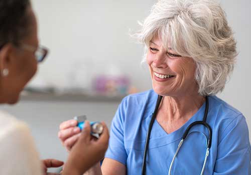 Tile - Respiratory Therapy - Nurse showing patient how to use inhaler