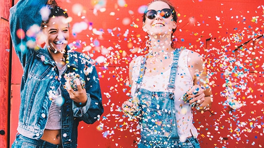 Happy girls with confetti.