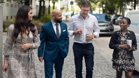 Allianz colleagues in a joyful conversation while walking