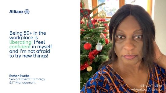 Woman in front of a christmas tree looking at the camera