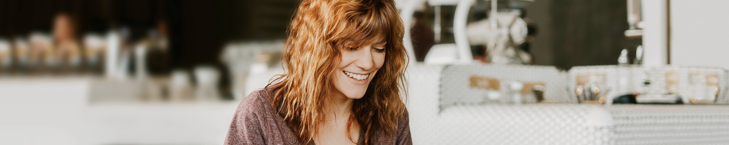 Woman smiling in a work environment.
