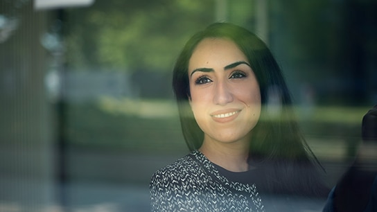 Women in front of a window smiling 