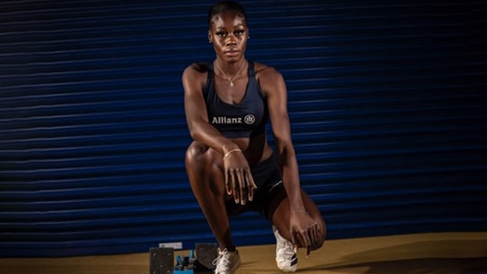 Sprinter sitting in the front of a blue gate 