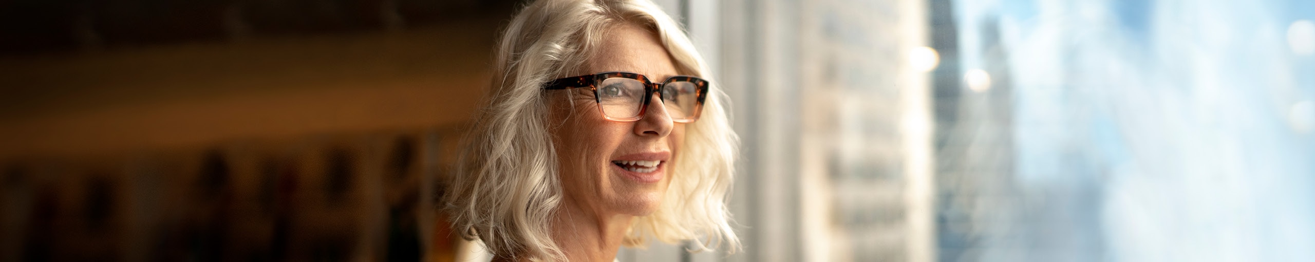 Women looking out of the window and wearing a glasses