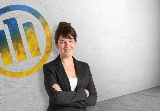 Women smiling in front of Allianz logo