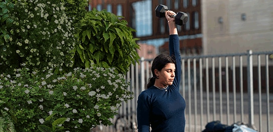 Women working out with some weights outdoor
