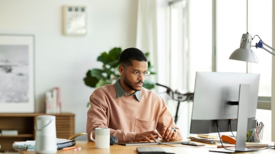 A graduate working on a laptop
