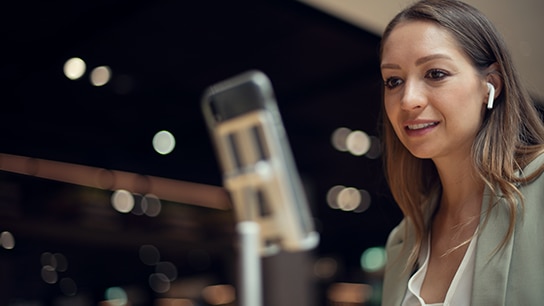 A colleague speaking into a microphone.