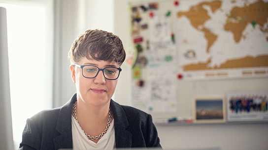 A person wearing glasses, looking forward