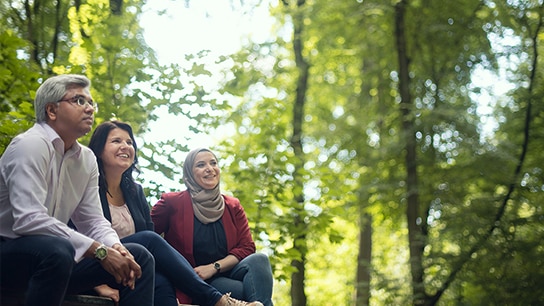 Three colleagues enjoying nature's beauty, showcasing diversity
