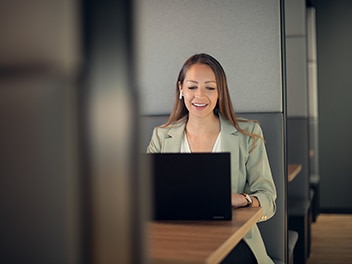 A happy employee working on a laptop