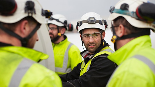 Andrew in focus, surrounded by colleagues