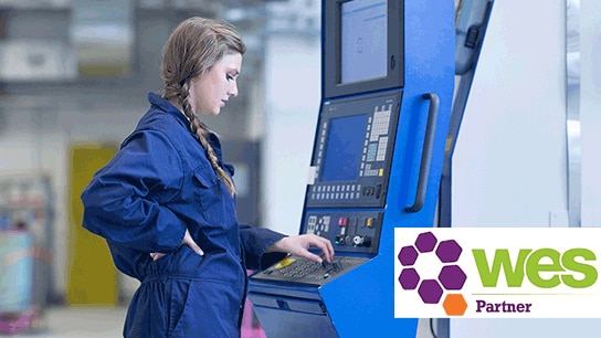 A female engineer working on a machine.