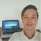 Mann vor seinem Laptop mit weißem Hemd