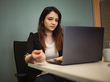 An employee working on a laptop 
