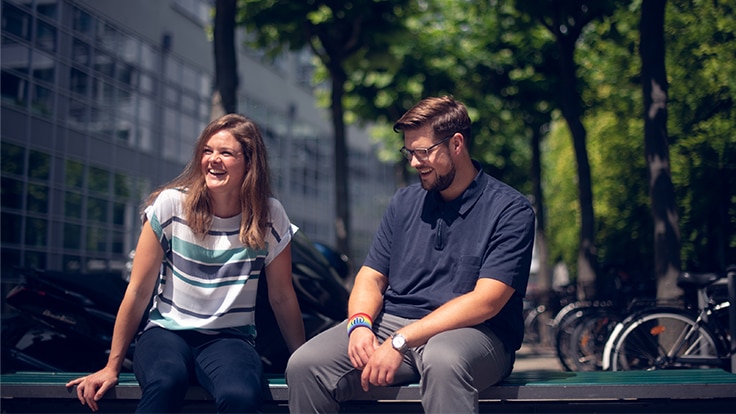 Katharina and her colleague engaged in a joyful conversation