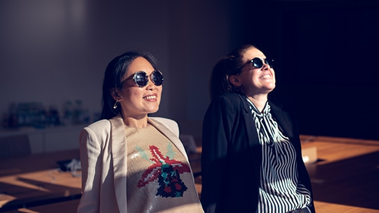 Katharina with her colleague chilling under the sun with sunglasses on