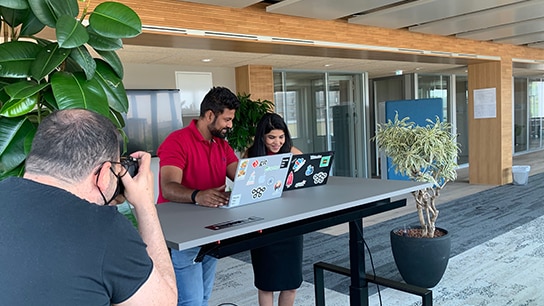 Shot of a video shoot of two colleagues working on their laptops