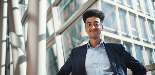 Man standing outside and smiling in camera