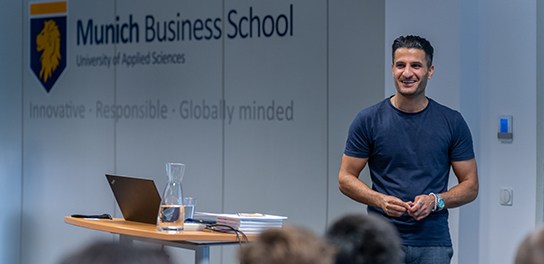 Senior recruiter leading a session, holding a pen with a whiteboard behind.