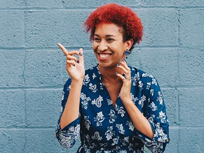 Happy woman with cheerful expression pointing her finger