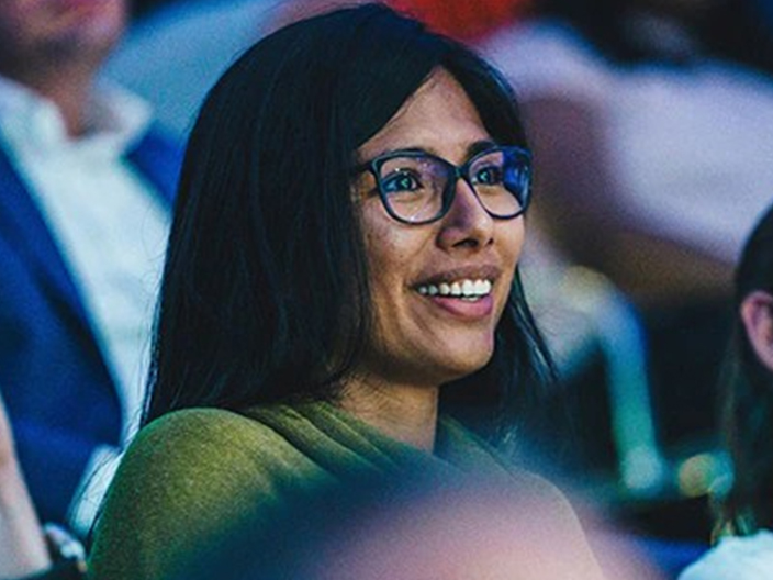 Happy, cheerful woman wearing glasses, laughing and looking away