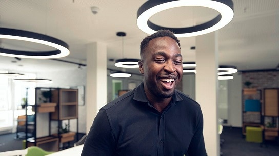 Young Allianz employee with cheerful expression