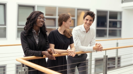 Young colleagues in a joyful conversation showcasing diversity