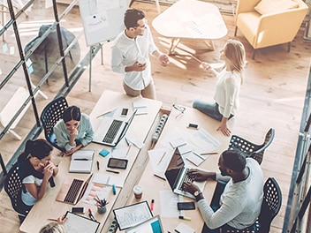 Top view of colleagues working in a vibrant workplace