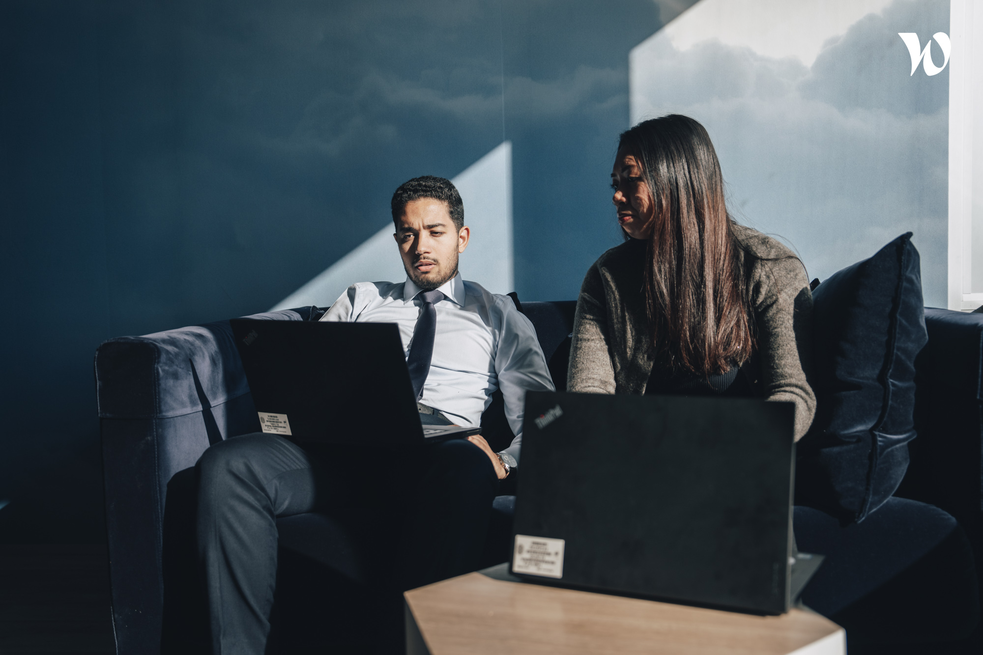 Employees sitting with laptops