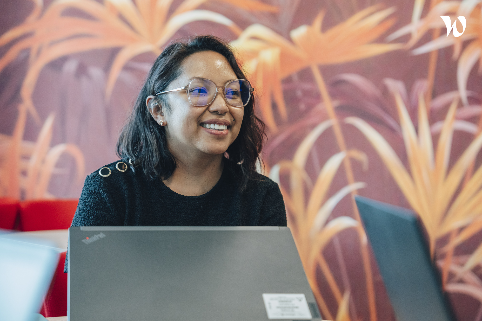 Woman sitting in front of laptop