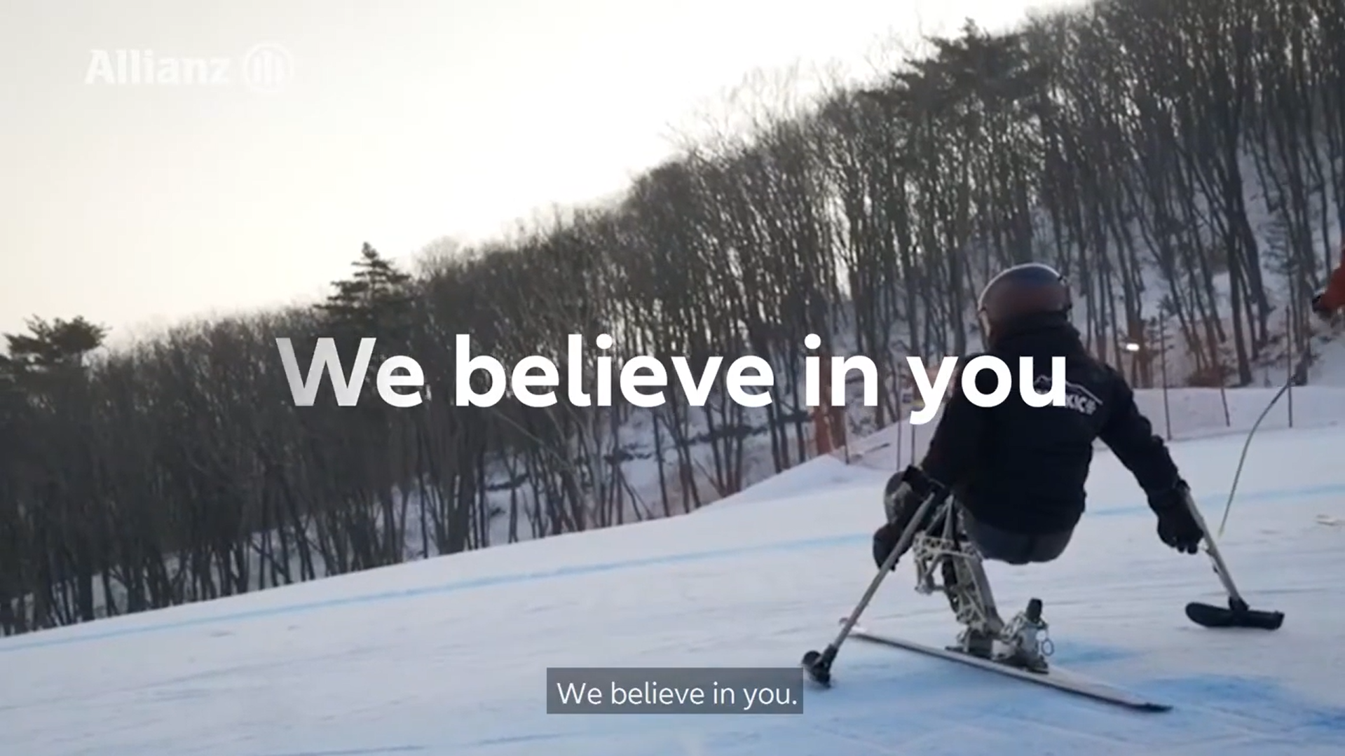 A skier confidently glides down a slope, accompanied by the encouraging phrase "We Believe in You" in bold text