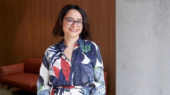 A person wearing glasses and a floral dress