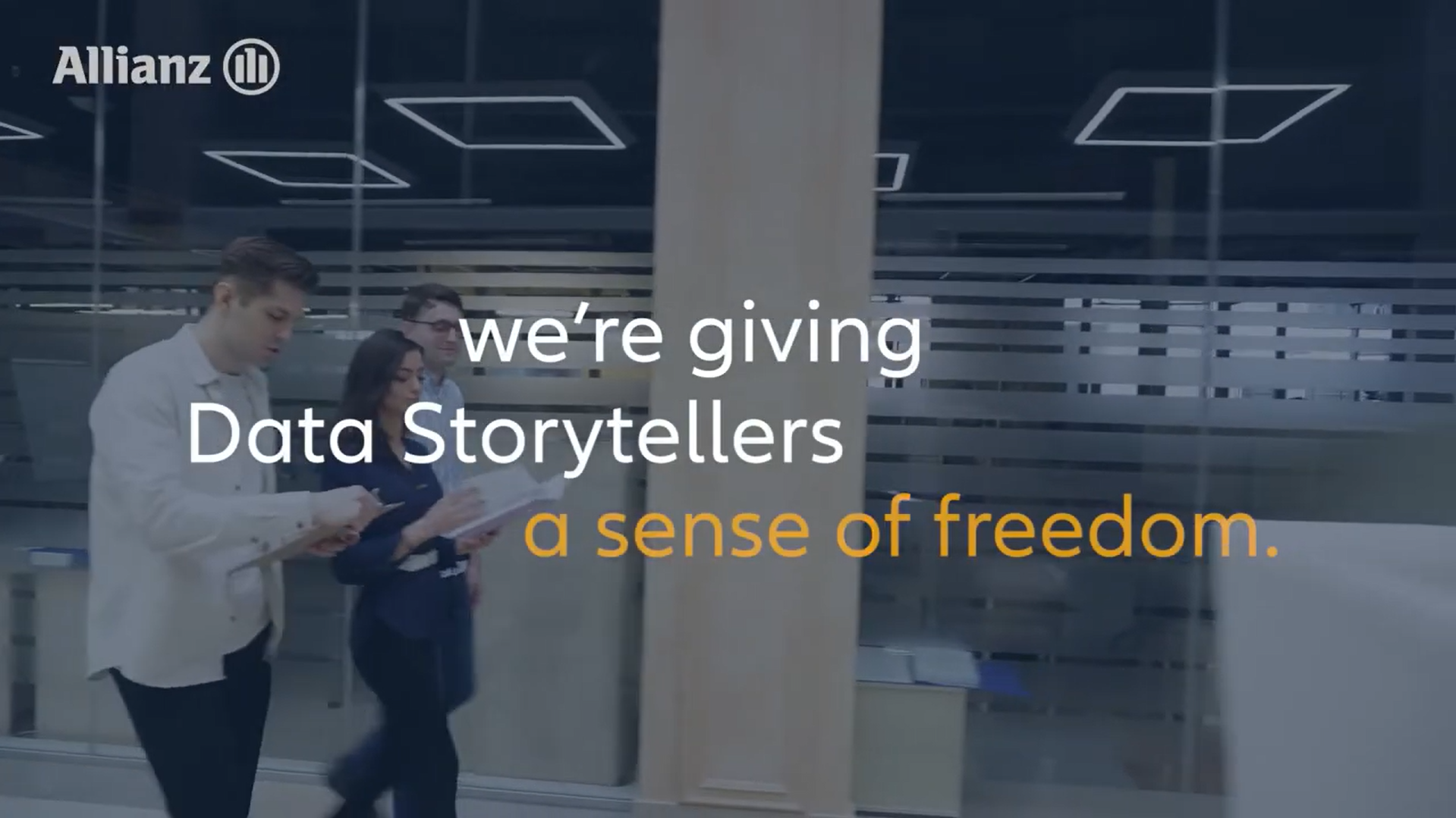 Three professionals walking together with text overlay saying "We're giving Data storytellers a sense of freedom."