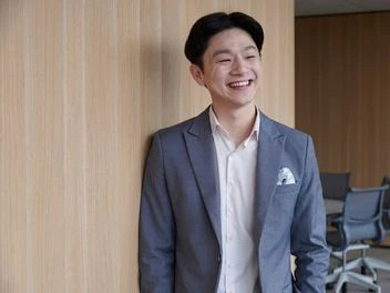 Smiling employee in a professional workspace, embodying the company’s commitment to employee satisfaction and career development