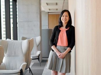 Employee smiles at the camera, reflecting a relaxed yet professional atmosphere.