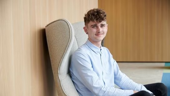 Head shot of Liam seated in a couch