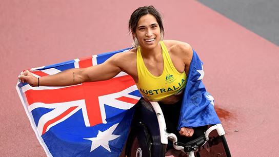  Madison, a woman in a wheelchair, proudly holds the Australian flag