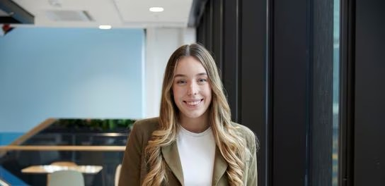 A young employee smiling at the camera