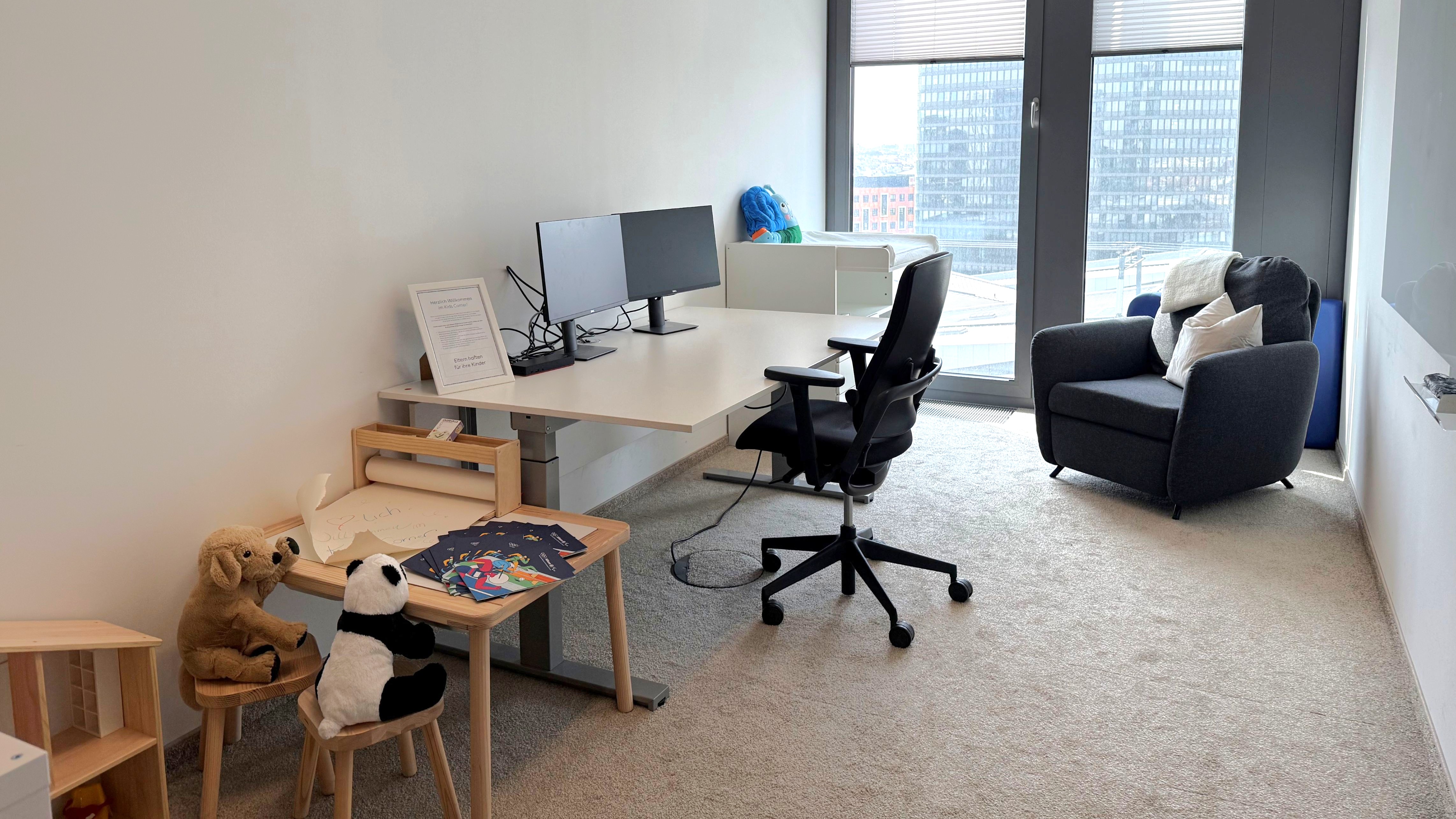 Room with working desk and place for kids to play
